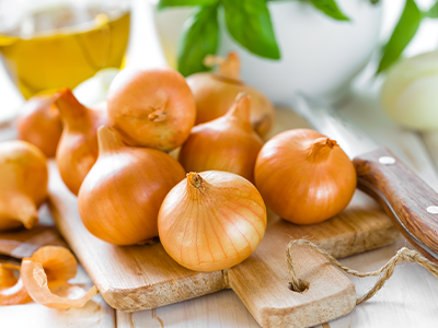 Yellow Onions on a cutting board